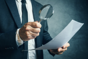 accountant with magnifying glass