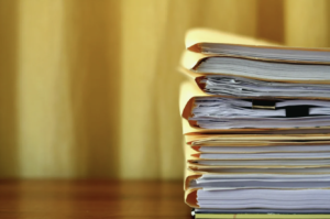 stack of folders containing old tax documents