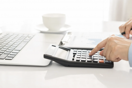 tax accountant using calculator for forecasting tax savings